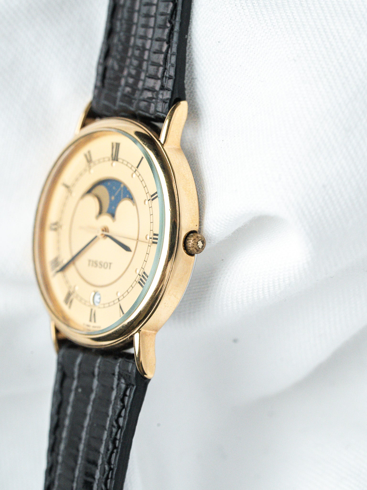 Tissot vintage watch with gold case, cream dial, moon phase, black leather strap
