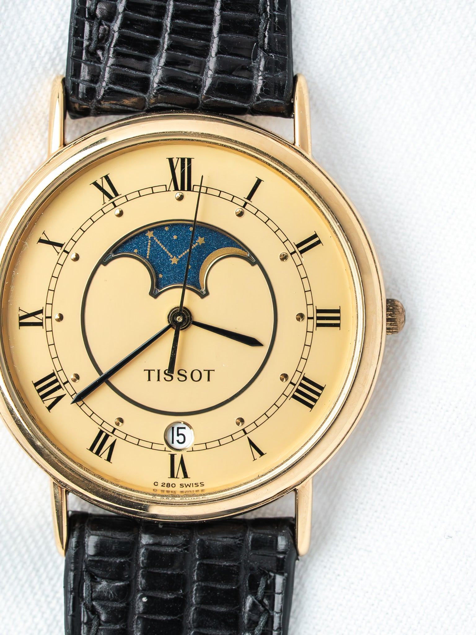 Tissot vintage watch with gold case, cream dial, moon phase, black alligator strap