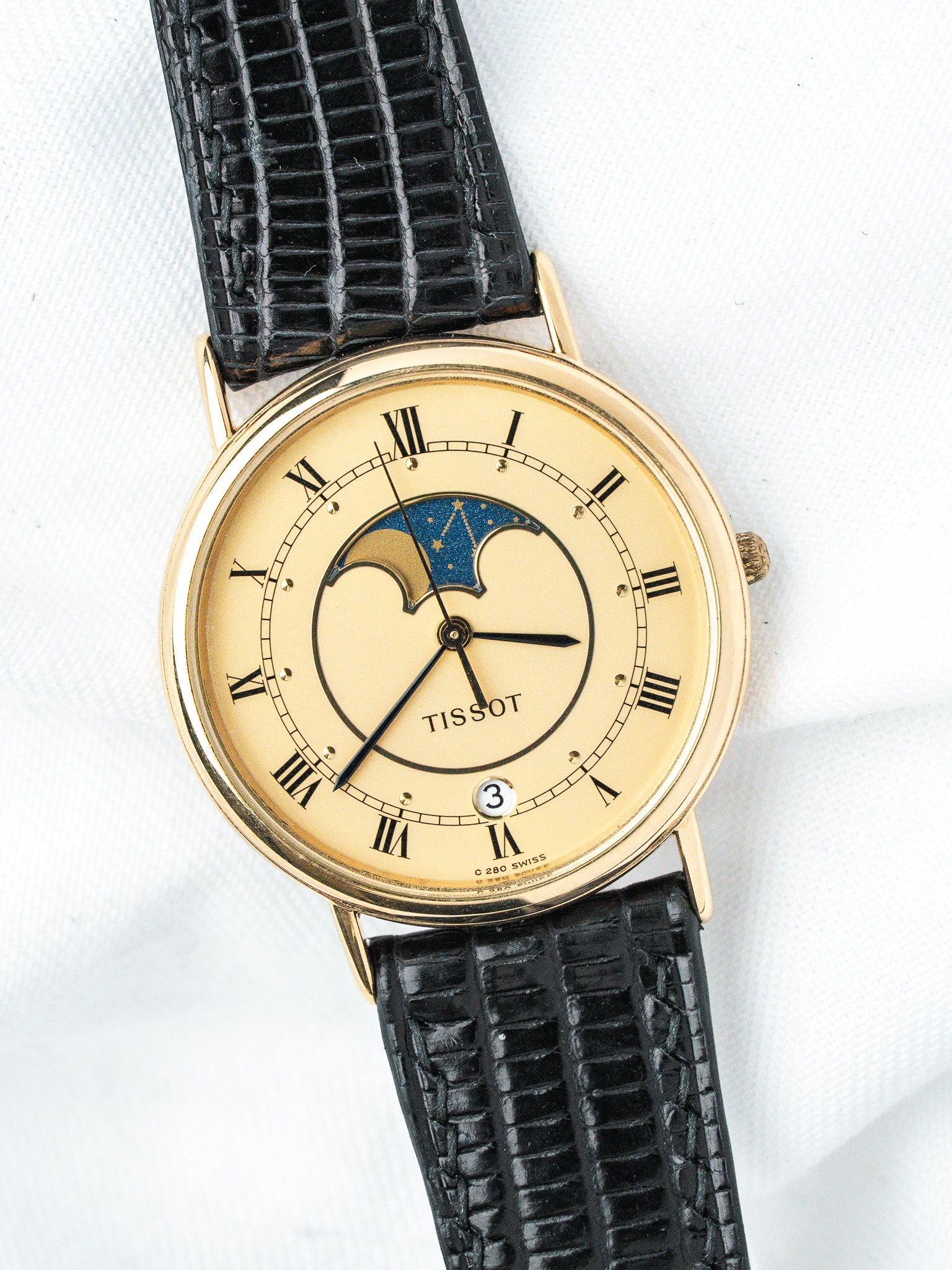 Tissot vintage watch with gold case, cream dial, moon phase, black alligator strap