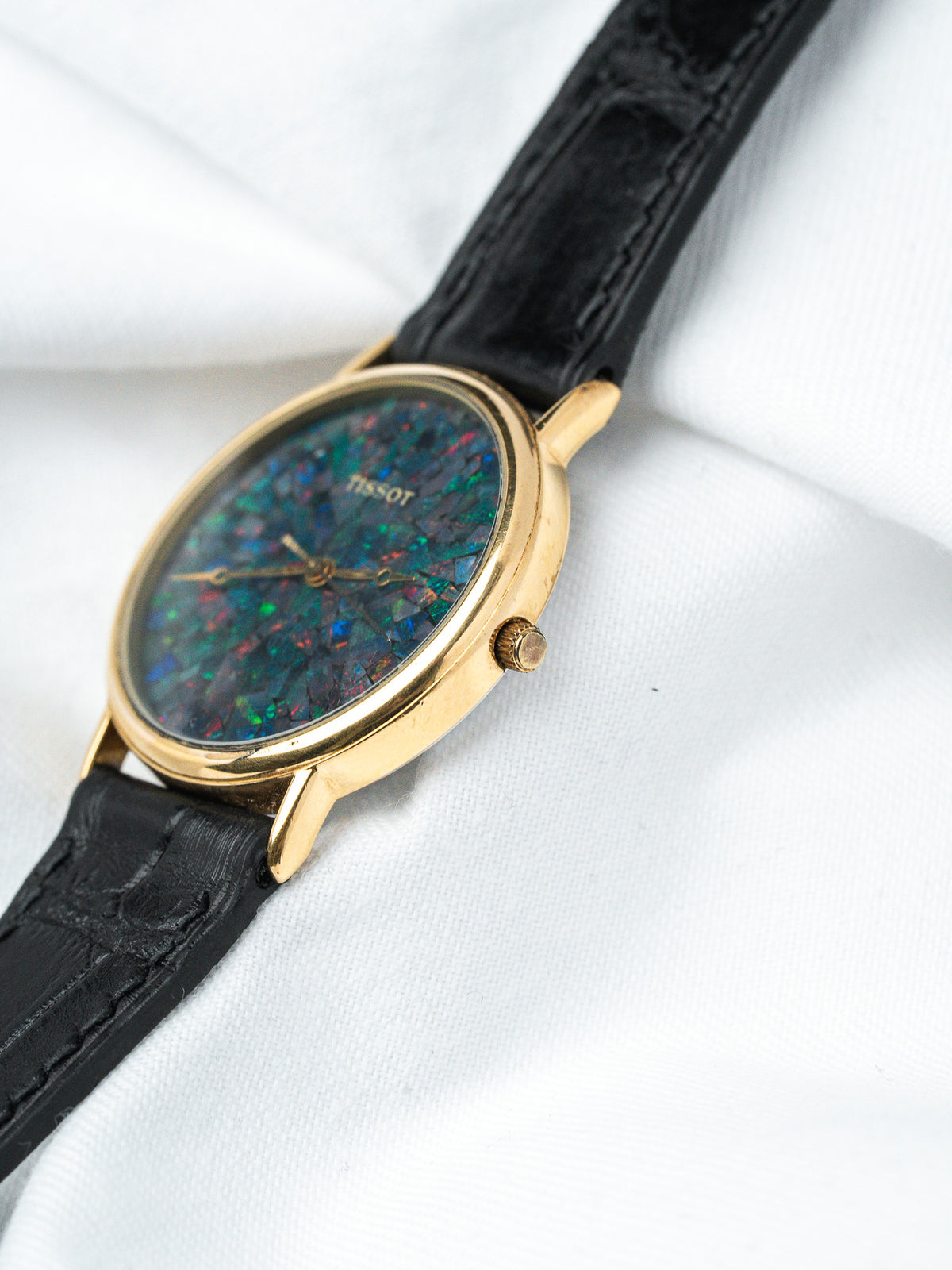 Tissot vintage watch with opal dial, gold case, black leather strap