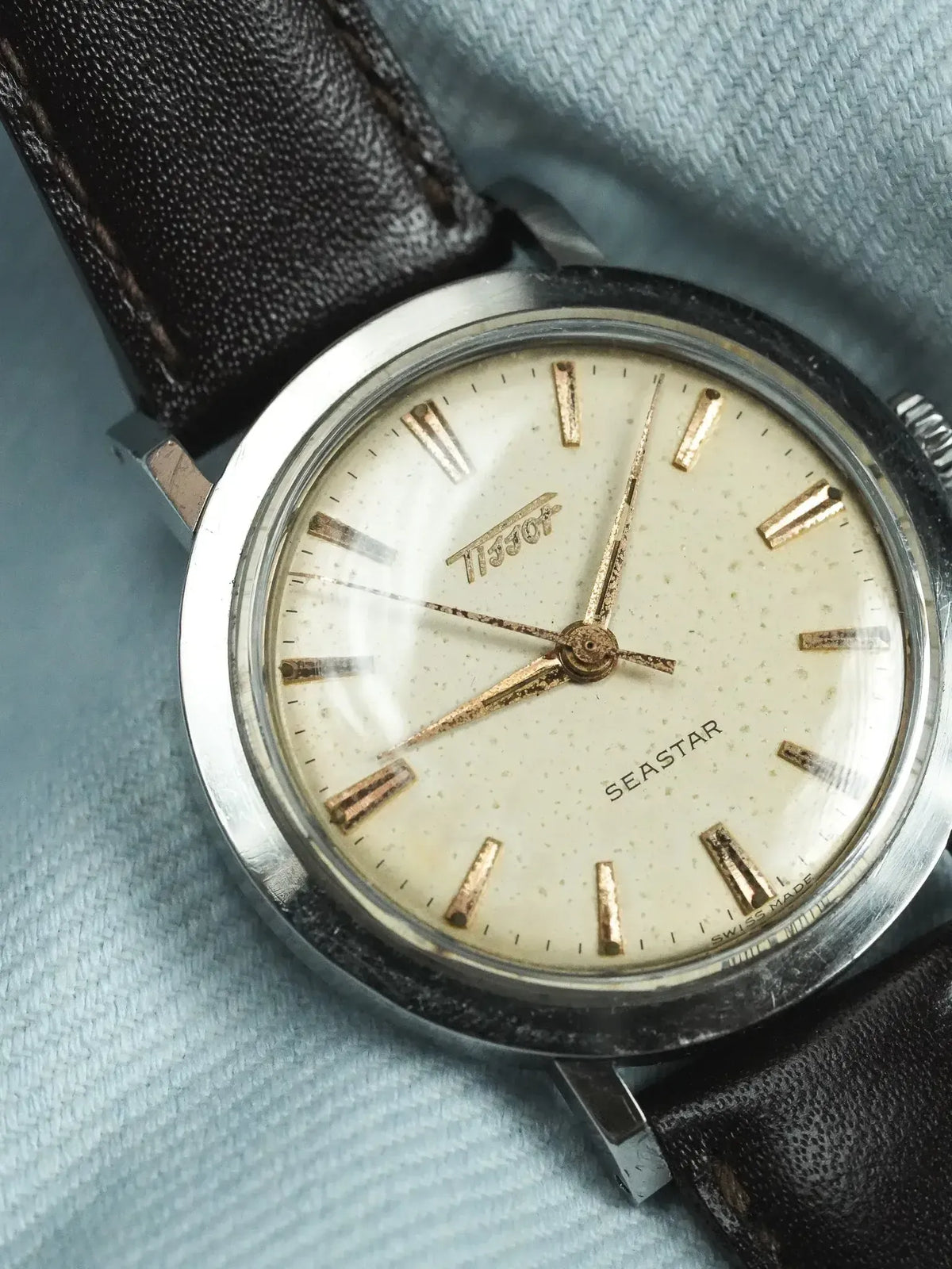 Tissot Seastar vintage watch with cream dial, gold markers, and black leather strap