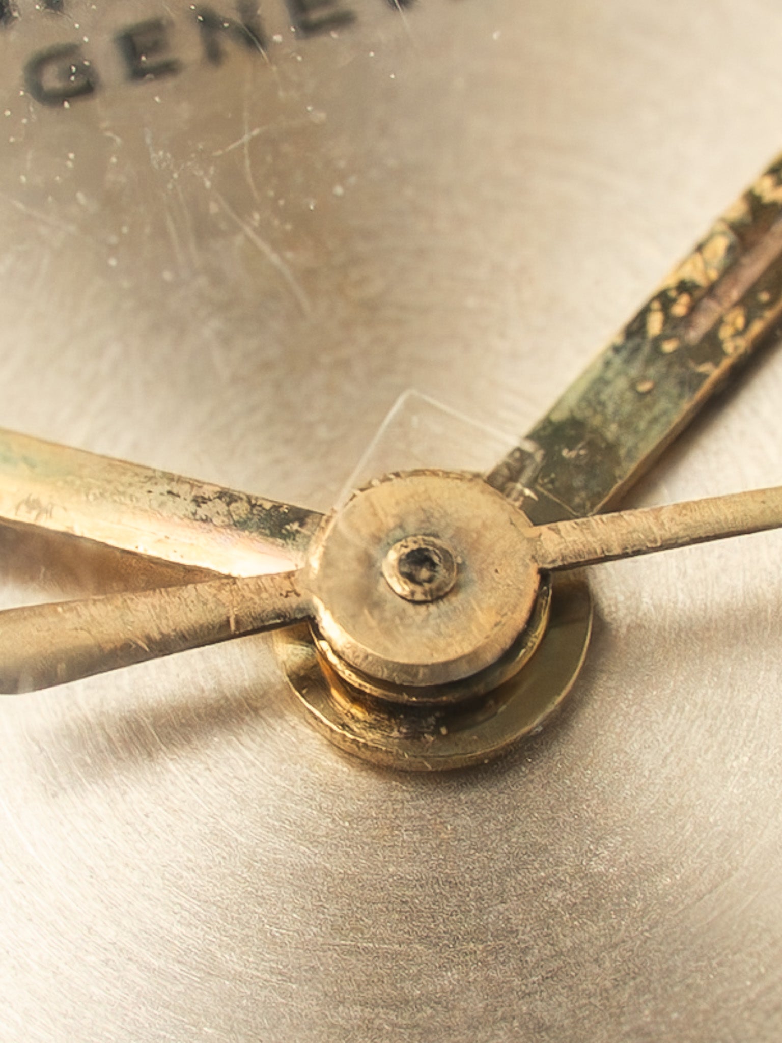 Universal Genève vintage watch hands and dial center, aged gold tone
