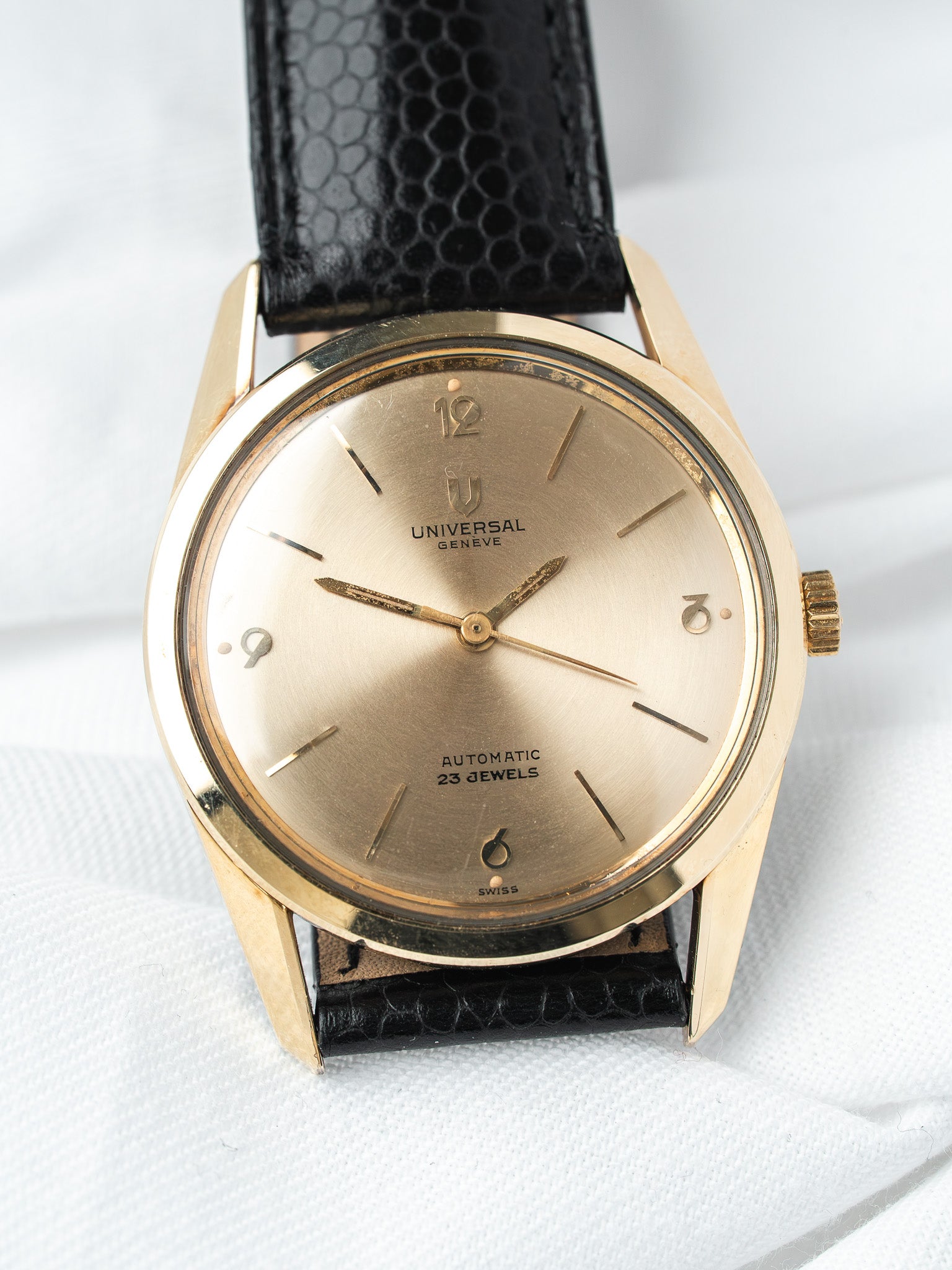 Universal Genève vintage automatic watch with gold case, champagne dial, black lizard strap