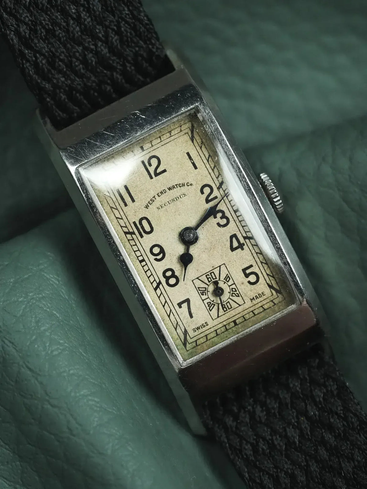 Vintage West End Watch Co. Secundus rectangular watch with cream dial, black numerals, and fabric strap
