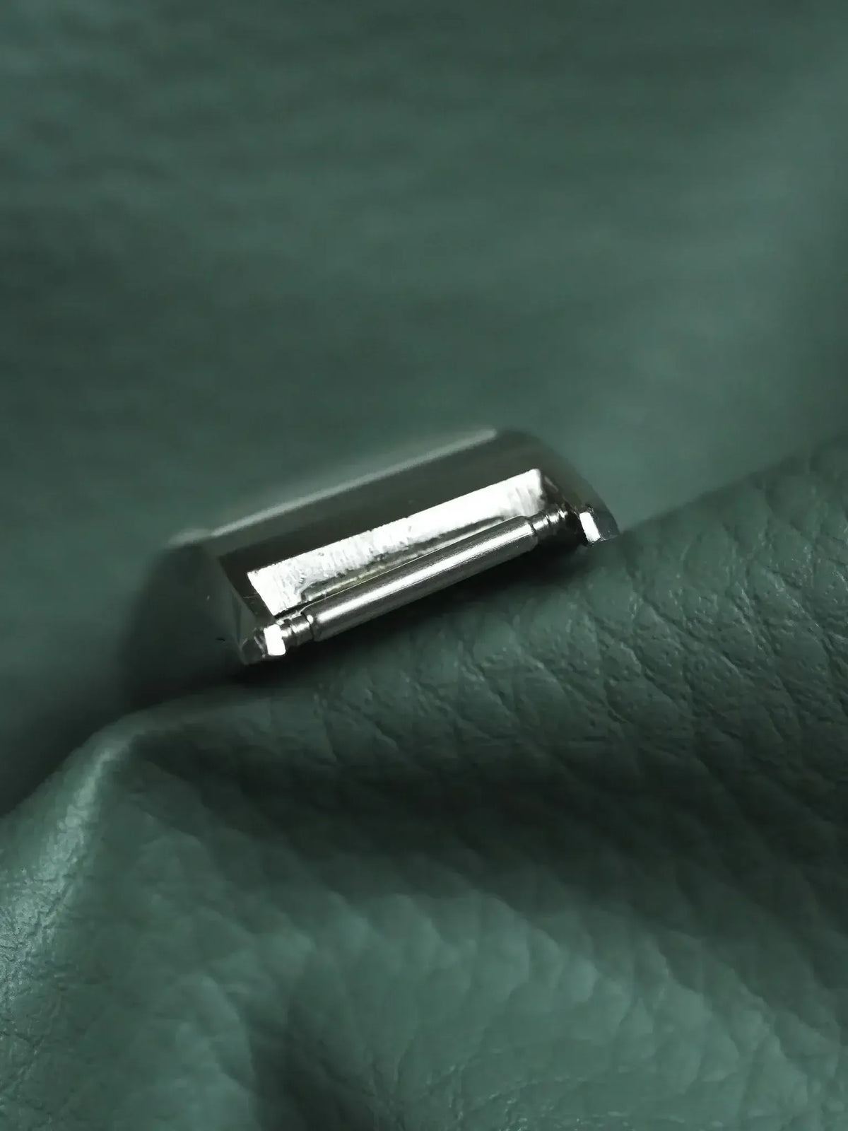Vintage Cartier Tank watch case back in polished steel on green leather