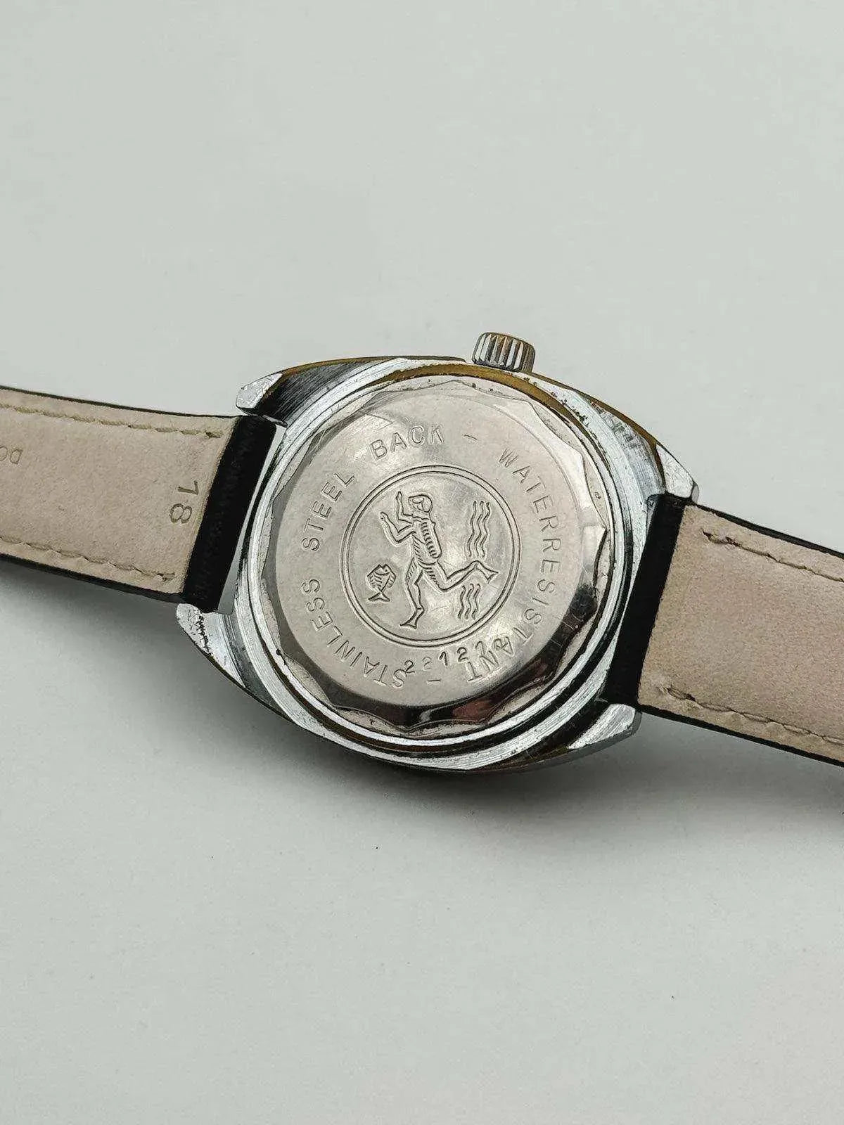 Vintage Omega watch with stainless steel back, engraved diver design, beige leather strap