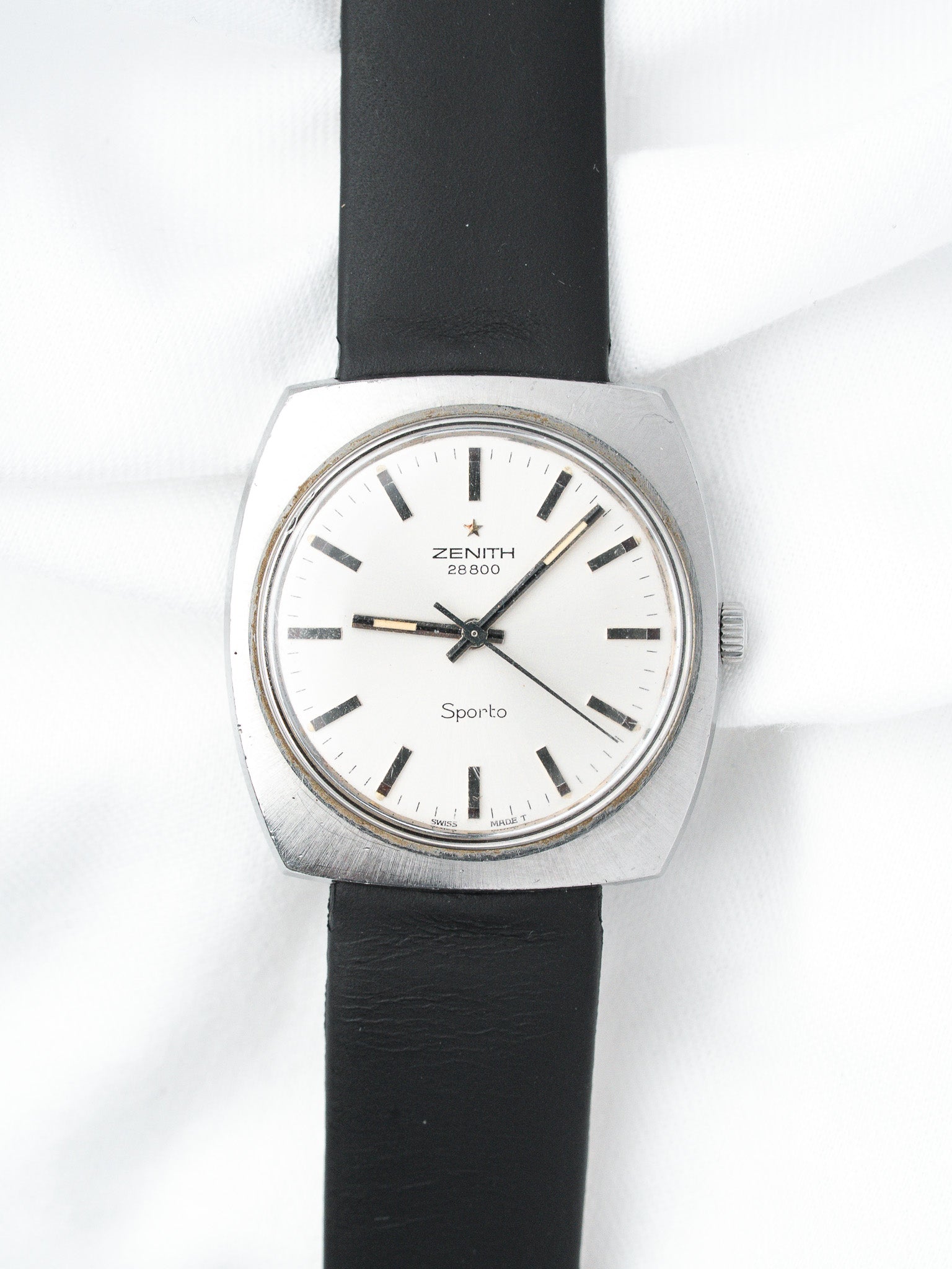 Zenith Sporto vintage watch with white dial, black leather strap, and steel case