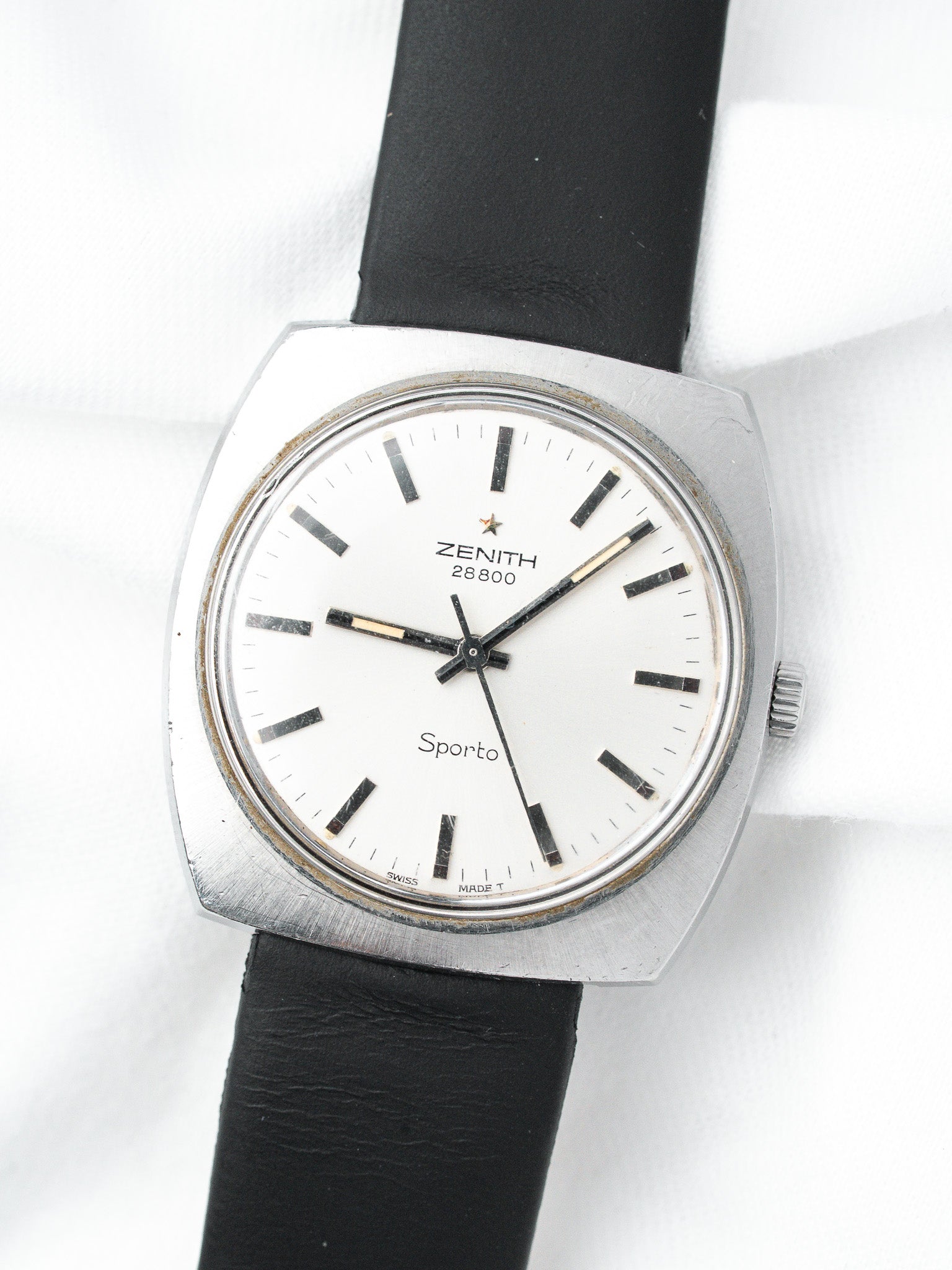 Zenith Sporto vintage watch with white dial, black markers, and black leather strap
