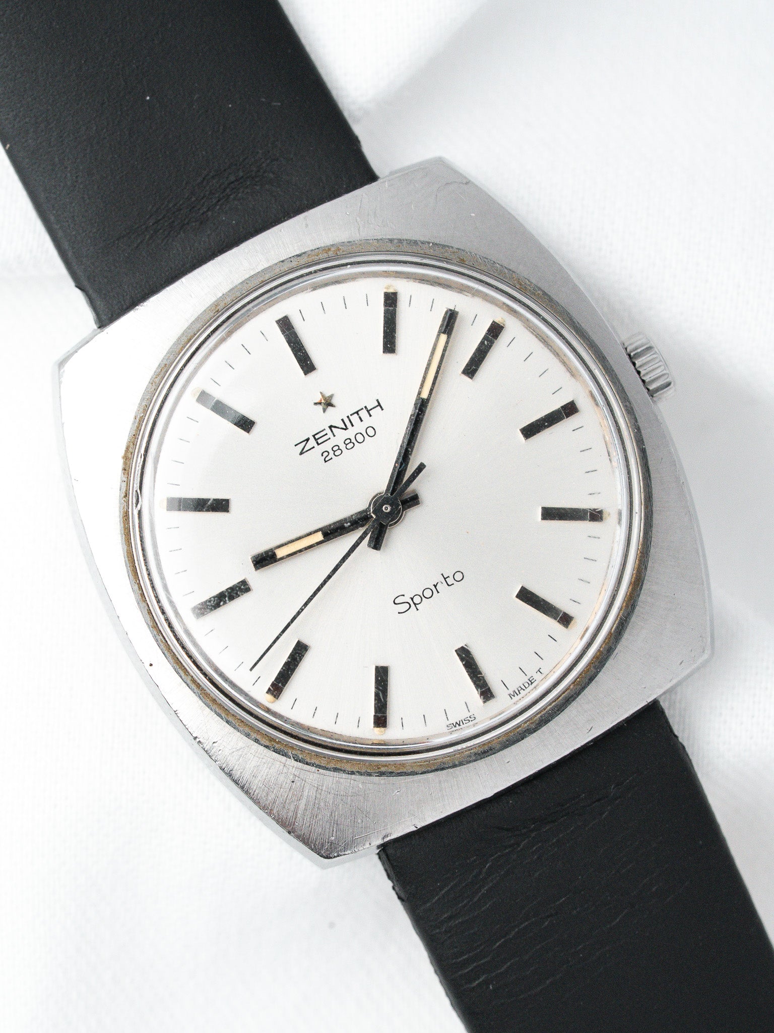 Zenith Sporto vintage watch with white dial, black markers, and black leather strap