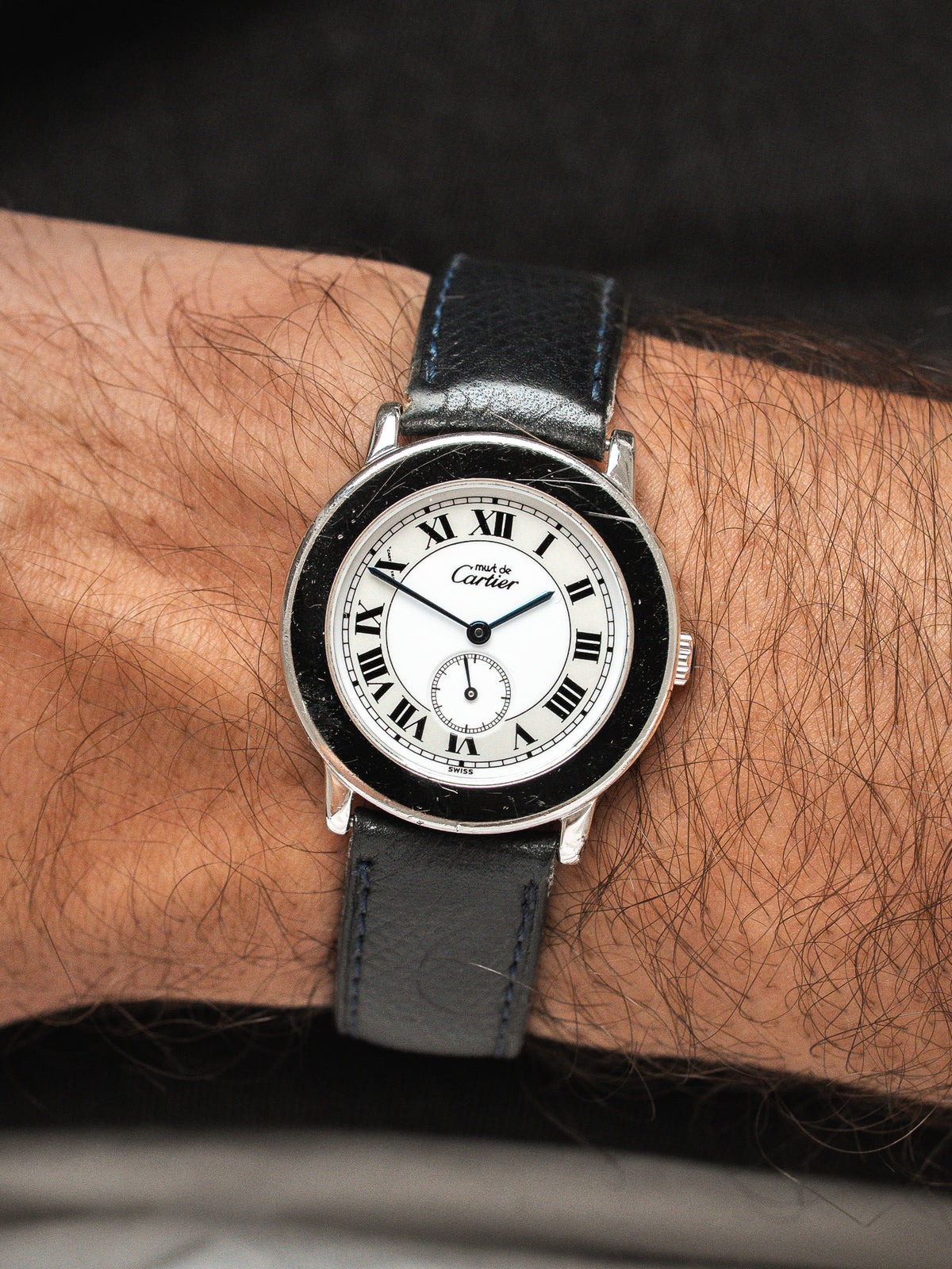 Montre Cartier vintage, boîtier rond en acier, cadran blanc et bracelet cuir noir