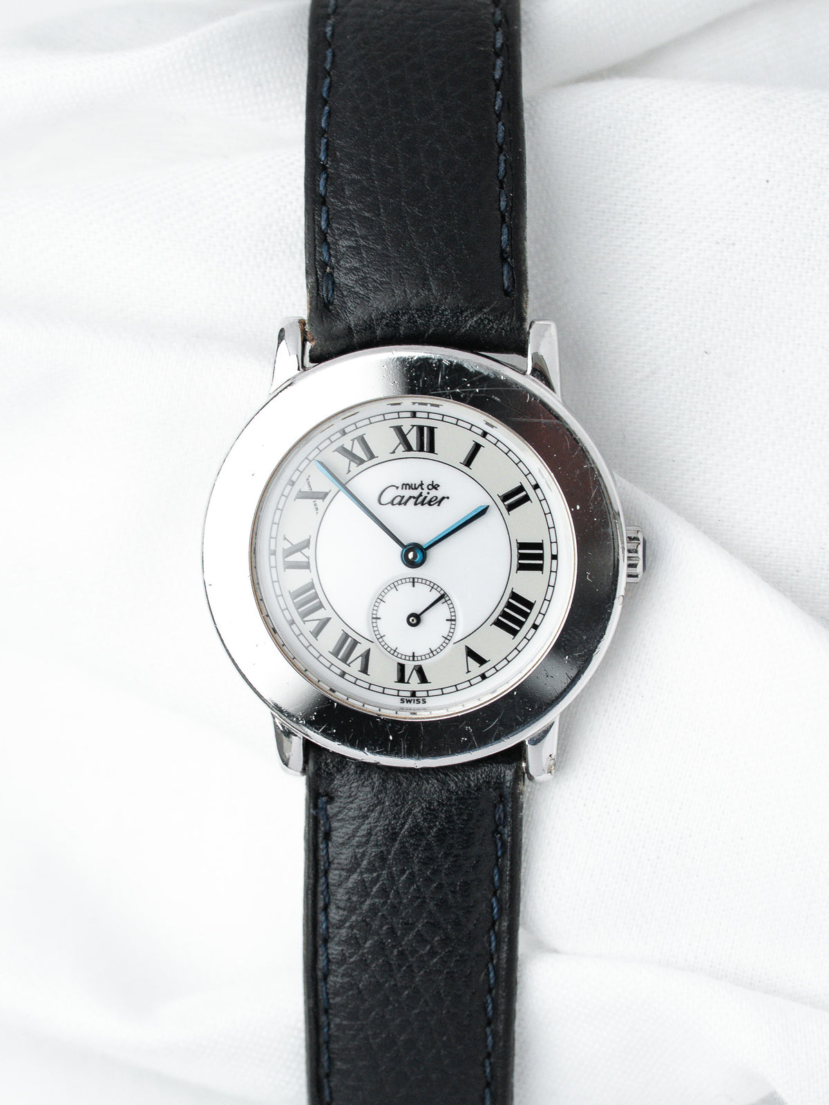 Cartier Must de Cartier vintage watch with white dial, Roman numerals, blue hands, black leather strap