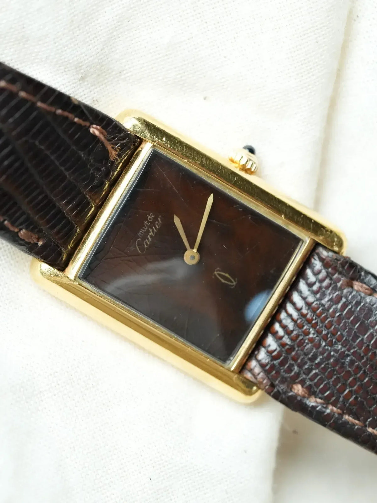 Cartier vintage watch with gold case, brown textured dial, and dark lizard strap