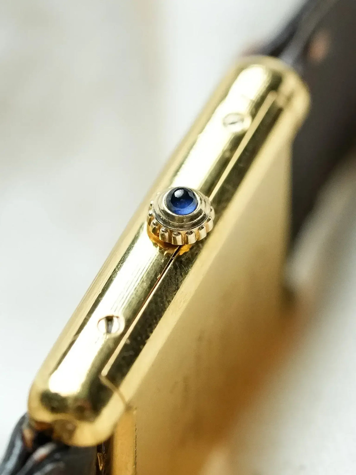 Cartier vintage watch with gold case and blue sapphire crown