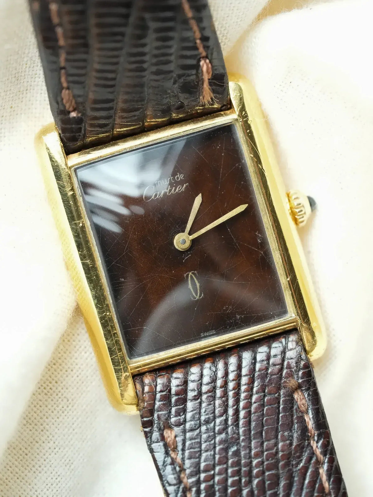 Cartier Must de Cartier vintage watch with gold case, brown dial, and textured leather strap