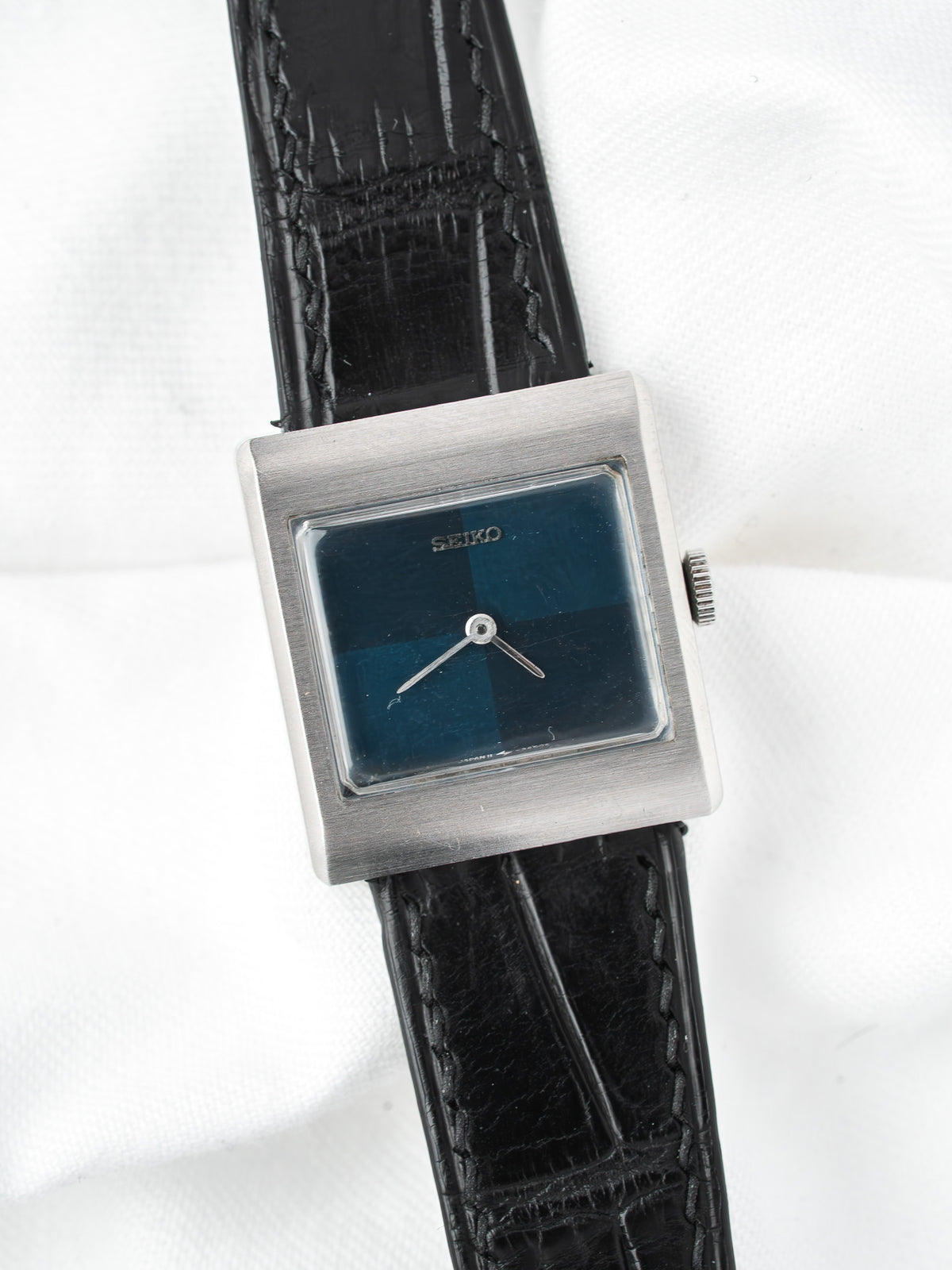 Seiko vintage watch with square silver case, blue dial, black leather strap