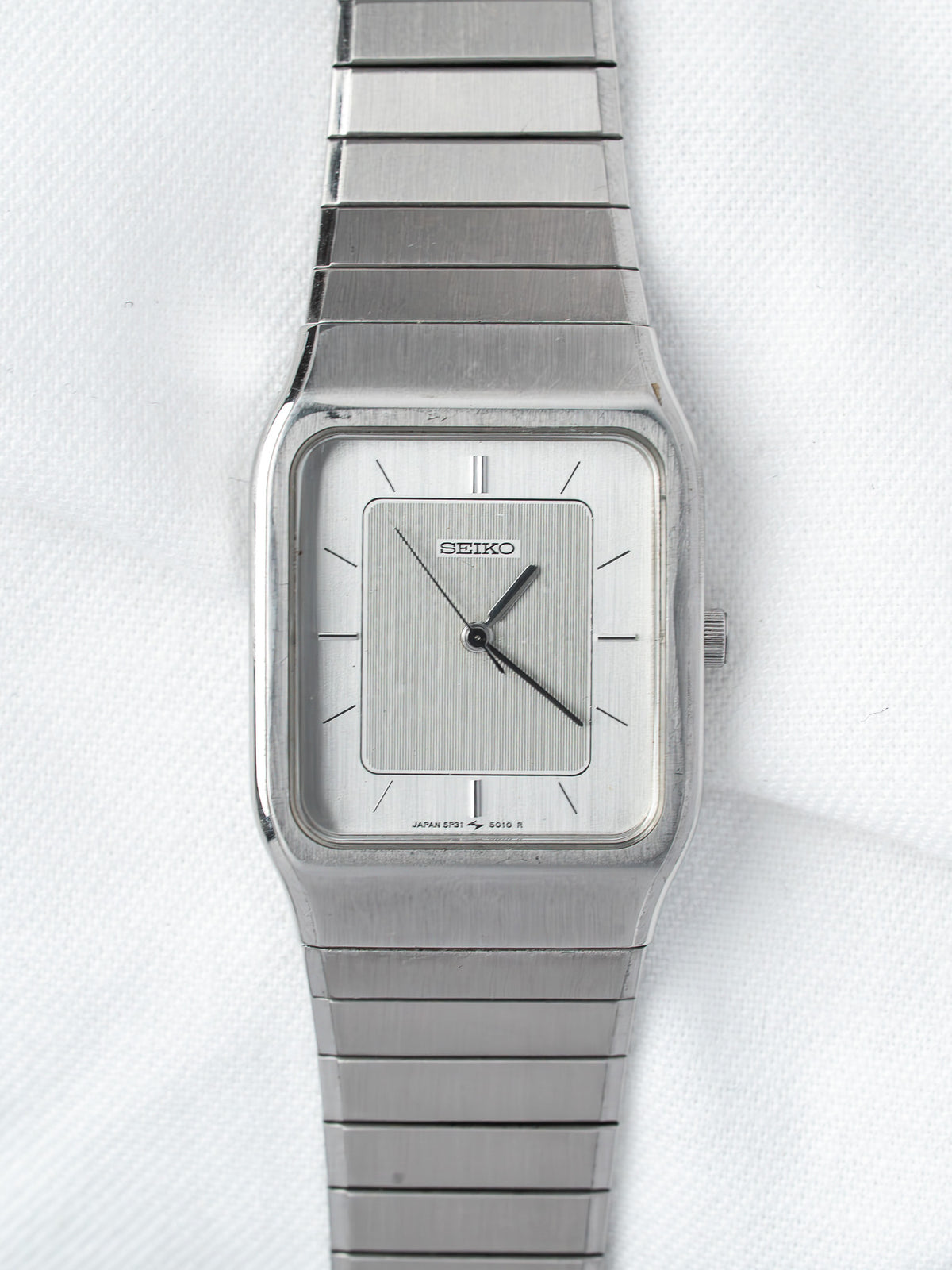 Seiko vintage watch with square silver dial and metal bracelet