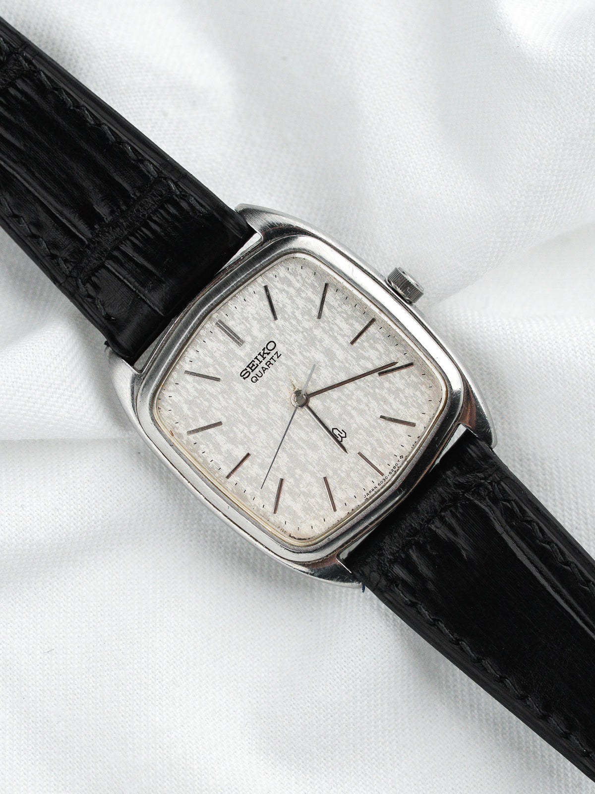 Seiko Quartz vintage watch with silver dial and black leather strap