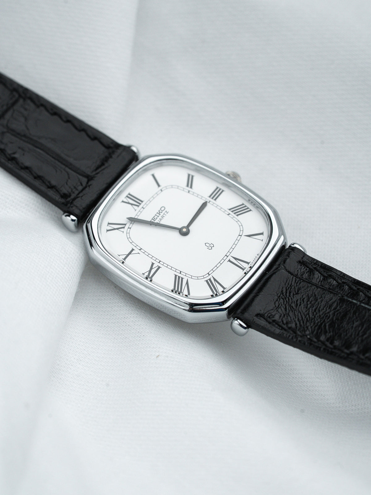 Seiko Quartz vintage watch with white dial, Roman numerals, black leather strap