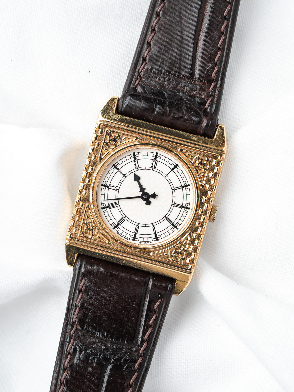 Vintage Seiko square watch with gold case, white dial, and brown leather strap