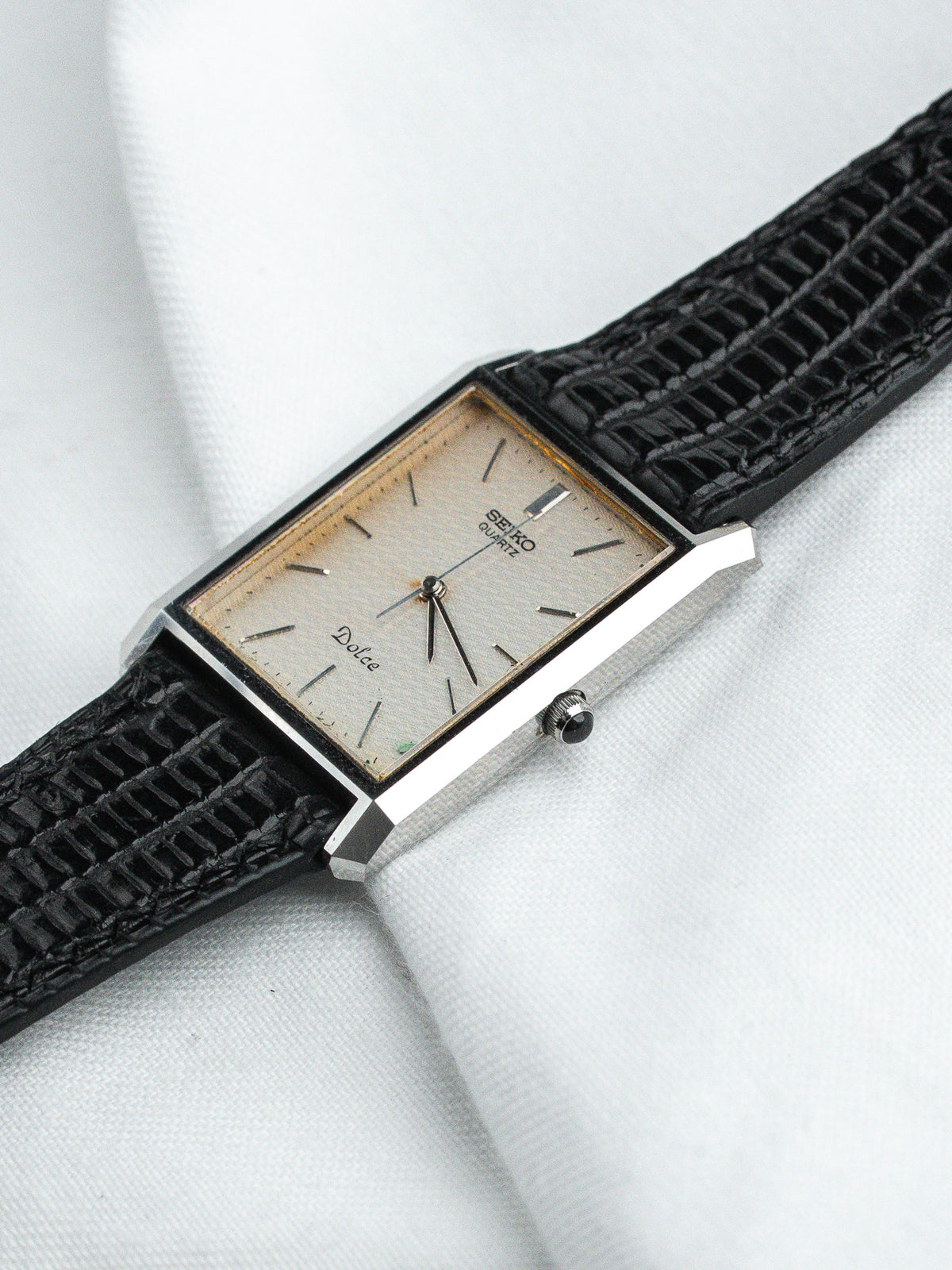 Seiko Dolce vintage watch with rectangular case, cream dial, black textured strap