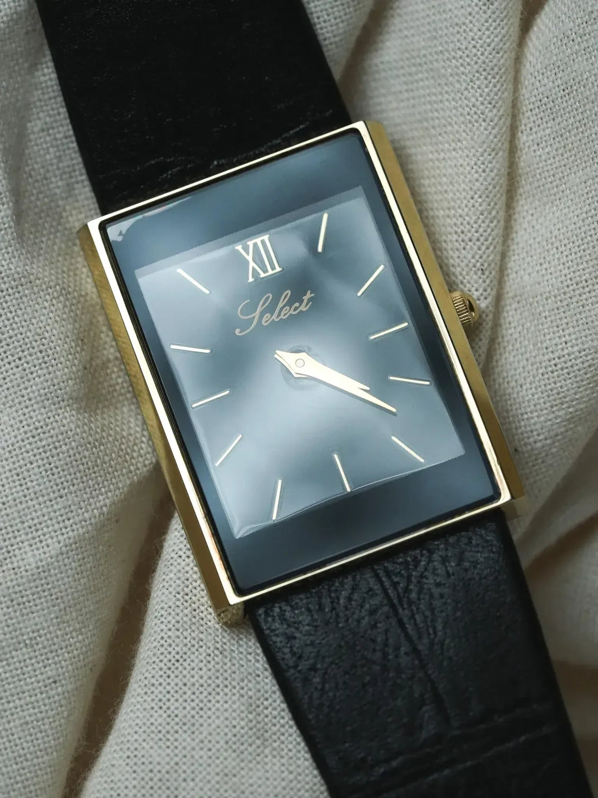 Select vintage watch with gold case, grey dial, Roman numeral, black leather strap