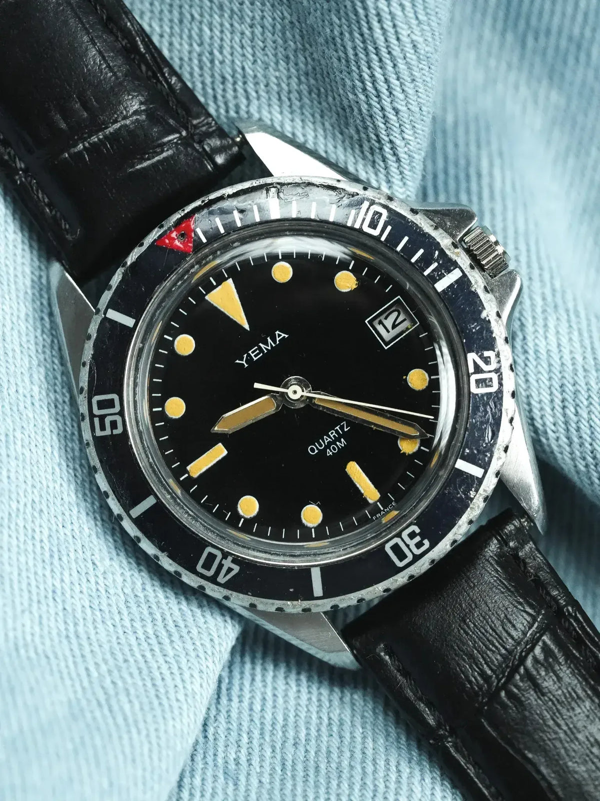 Yema vintage dive watch with black dial, yellow markers, and black leather strap