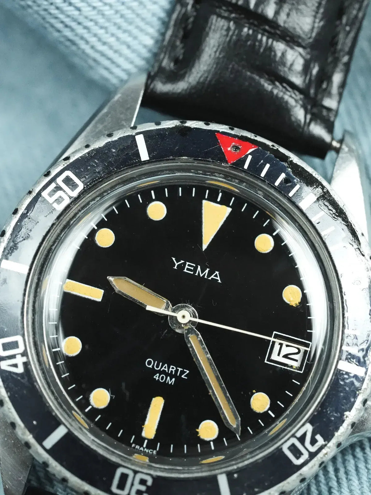 Yema vintage dive watch with black dial, luminous markers, and black leather strap