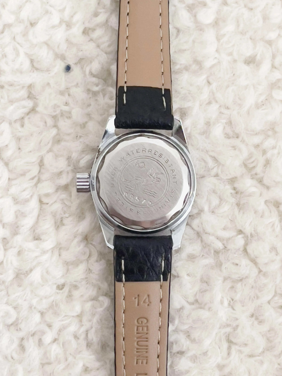 Vintage Omega Seamaster watch back with engraved diver logo, stainless steel case, black leather strap
